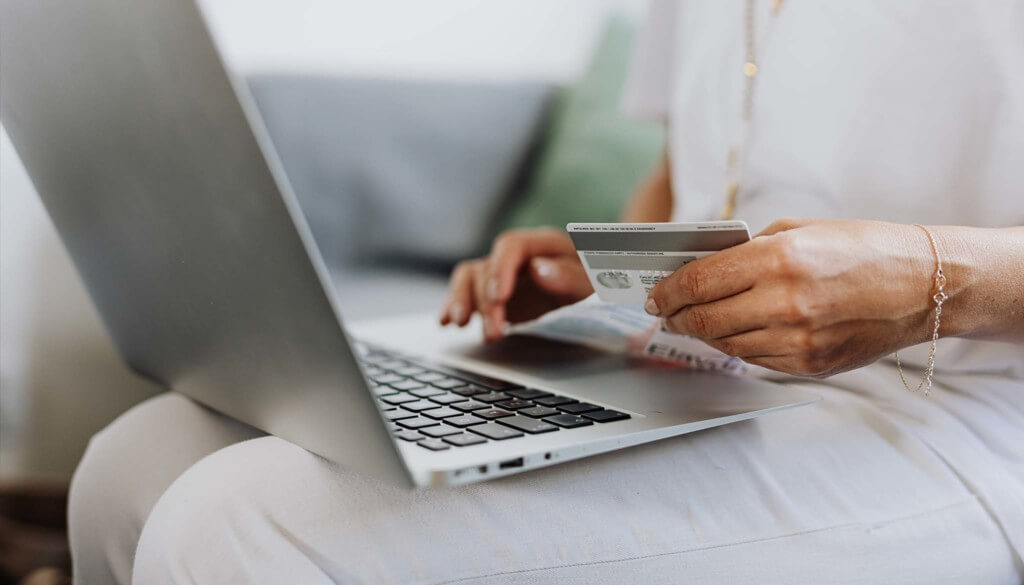 person using credit card to pay online