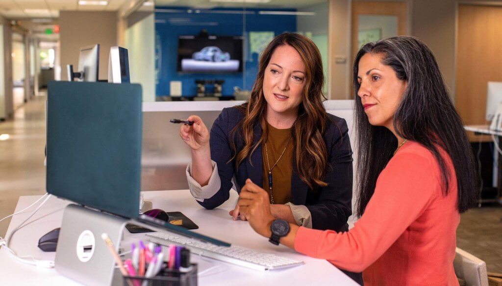 two women looking at laptop screen